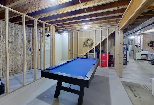 game room with concrete flooring, water heater, and pool table