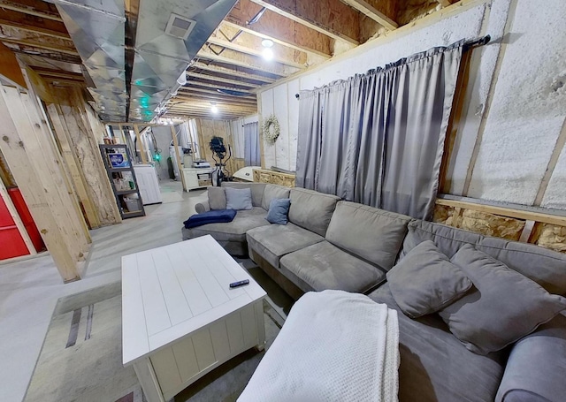living area featuring visible vents and concrete flooring