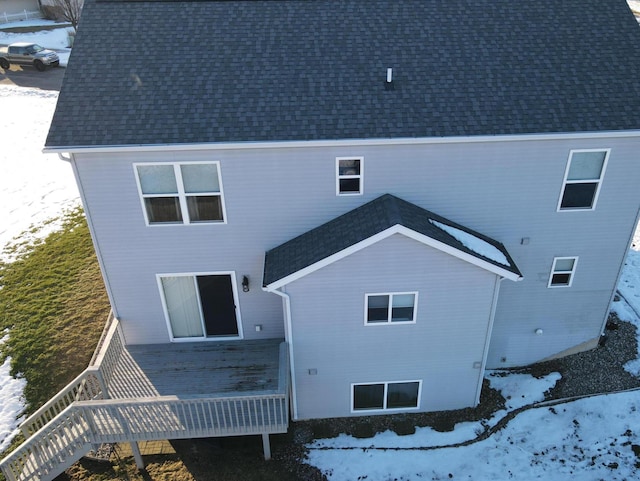 view of snow covered rear of property