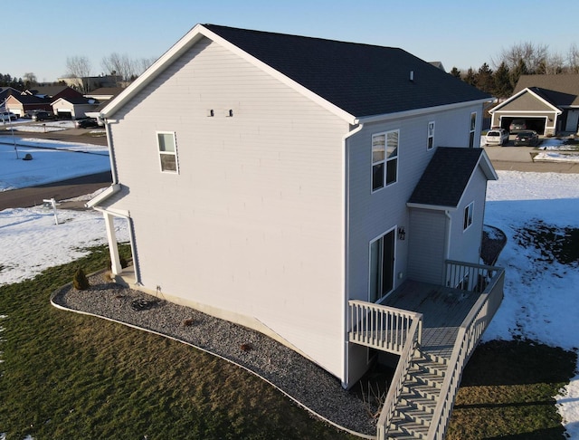 view of property exterior with stairway and a wooden deck