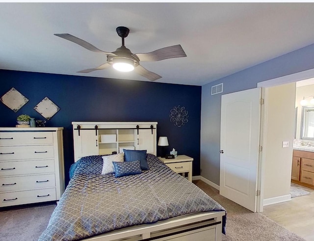 bedroom featuring visible vents, baseboards, a ceiling fan, carpet, and connected bathroom