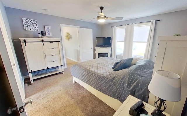 bedroom featuring baseboards, a ceiling fan, and light colored carpet
