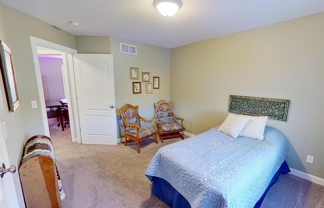 carpeted bedroom featuring visible vents and baseboards