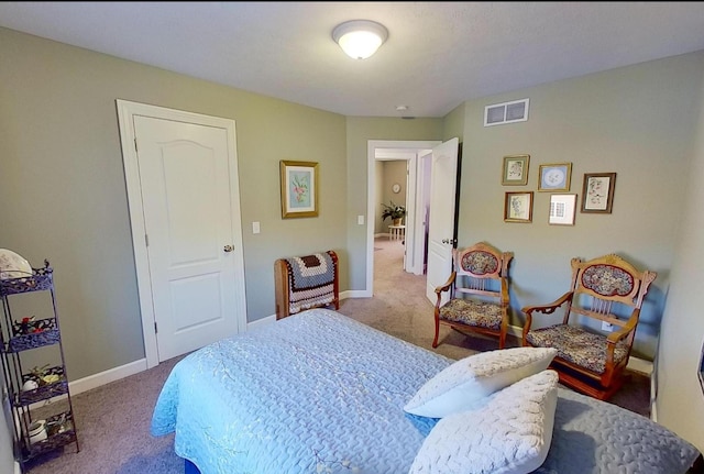 carpeted bedroom with visible vents and baseboards