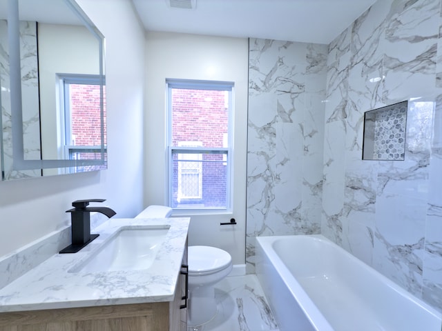 bathroom with vanity, a bath, and toilet