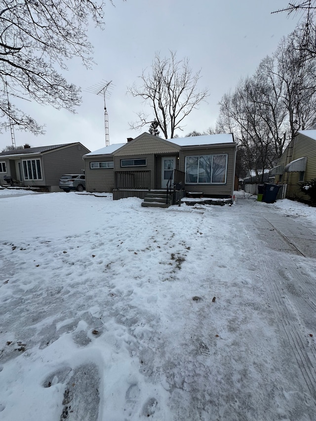 view of snow covered back of property