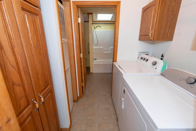 laundry room featuring cabinets and washing machine and dryer