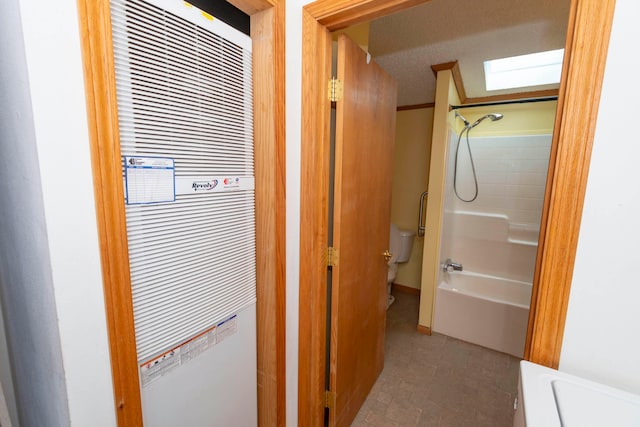 bathroom with shower / bathtub combination, toilet, and a textured ceiling