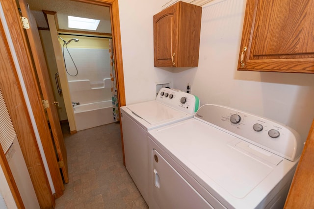 laundry room featuring cabinets, separate washer and dryer, and a skylight