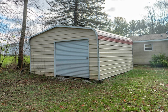 view of outbuilding featuring a lawn