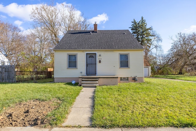 view of front of house with a front yard and a garage