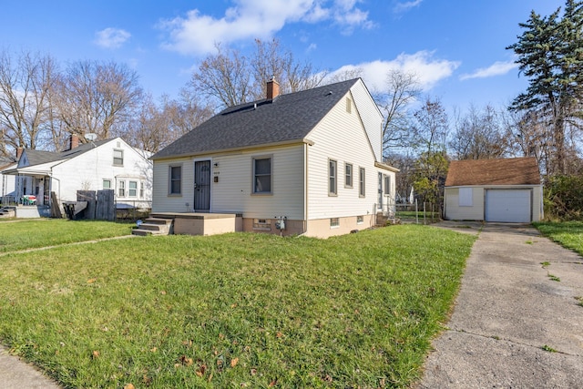 bungalow featuring a front lawn, an outdoor structure, and a garage