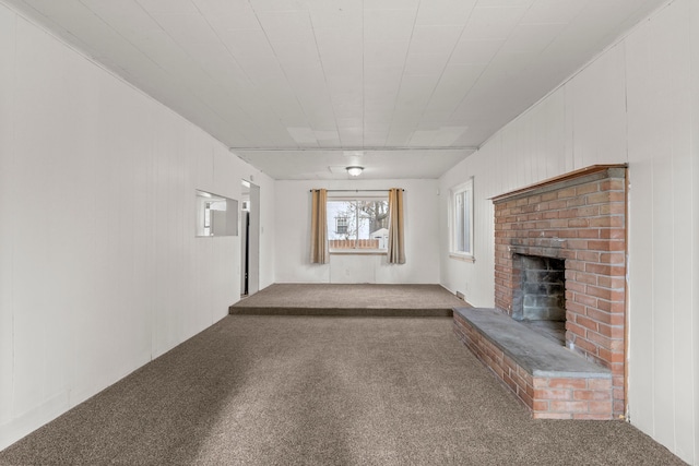 unfurnished living room with carpet flooring and a fireplace