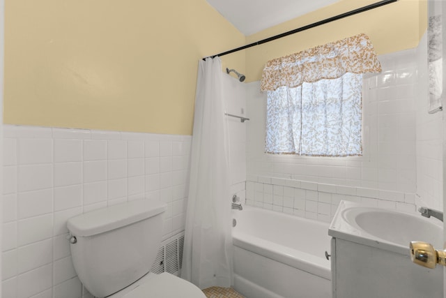 full bathroom with shower / tub combo, vanity, toilet, and tile walls