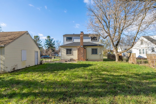 back of house with a lawn