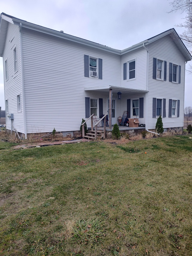 8789 Fowlerville Rd, Fowlerville, MI 48836 - view of front of property featuring covered porch, a front lawn, and cooling unit