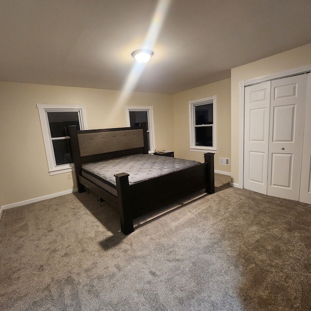 carpeted bedroom with a closet