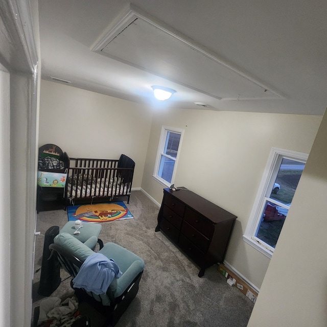 bedroom with carpet flooring and a crib