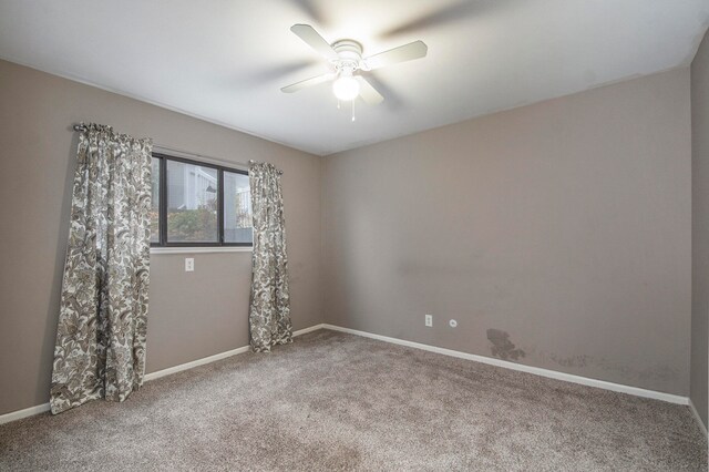 carpeted empty room with ceiling fan