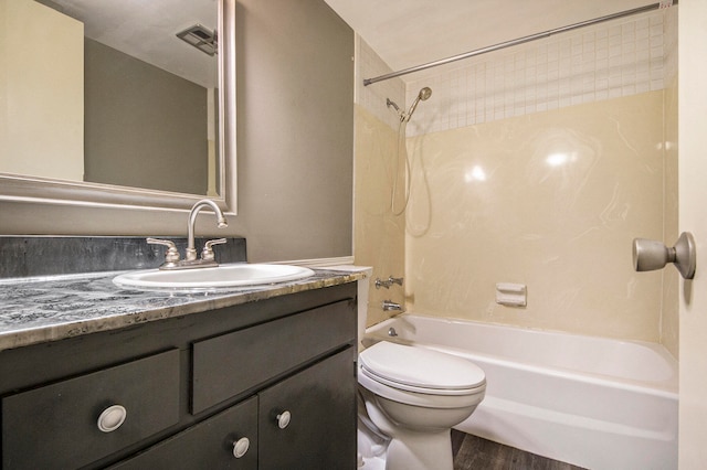 full bathroom with vanity, hardwood / wood-style floors, shower / bathing tub combination, and toilet