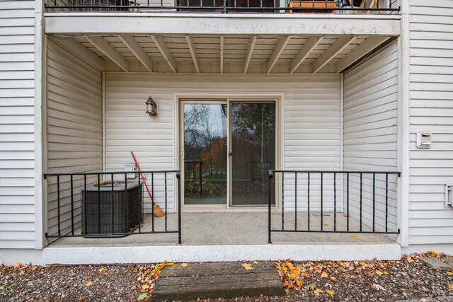 entrance to property featuring a balcony and central AC unit