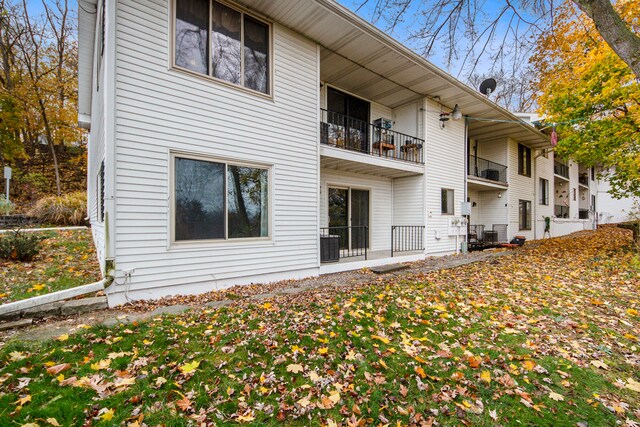 rear view of property featuring central AC