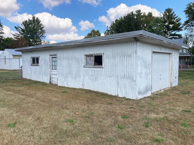 view of outbuilding with a yard and a garage