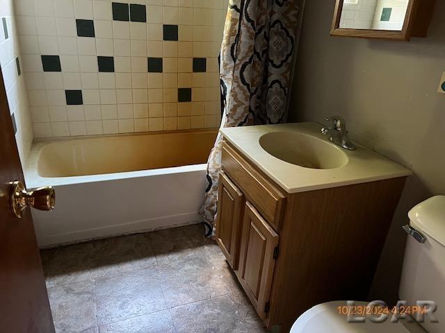 4209 Occidental Hwy, Adrian, MI 49221 - bathroom with toilet, vanity, shower / tub combo with curtain, and tile patterned floors
