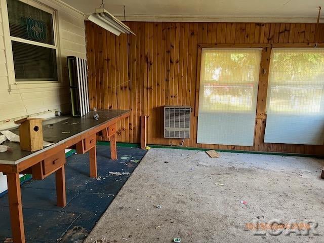 interior space with wooden walls and heating unit