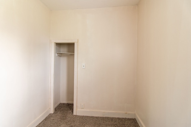 unfurnished bedroom with carpet floors and a closet