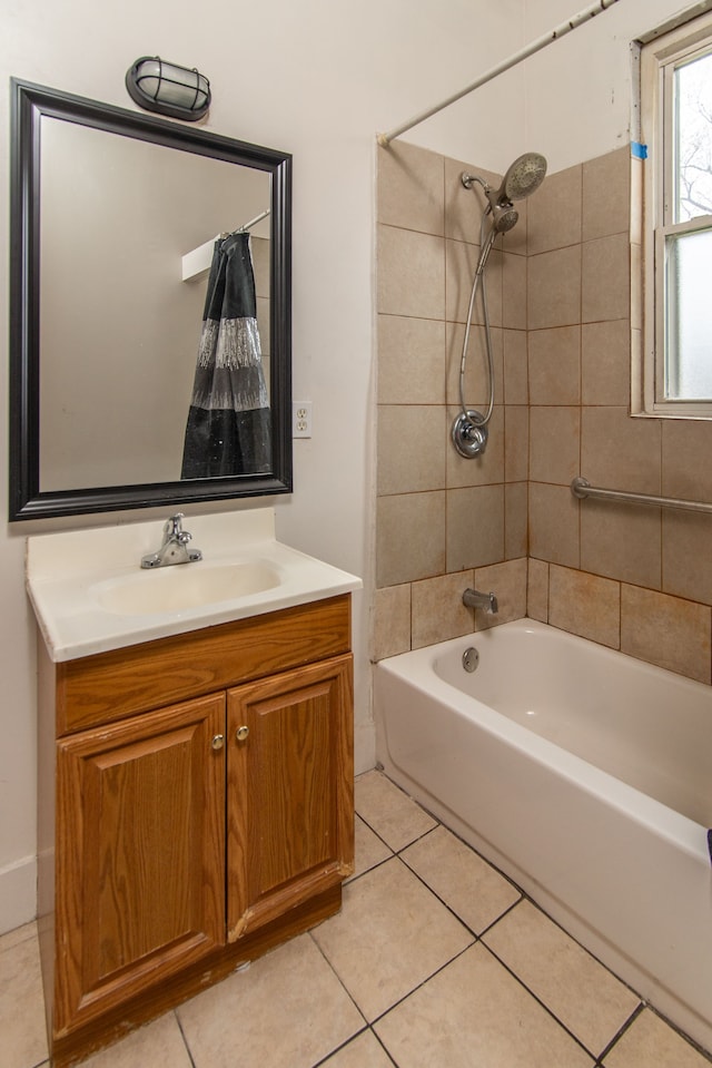 bathroom featuring tile patterned flooring, tiled shower / bath combo, and vanity