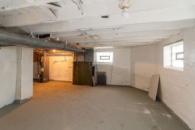 basement with brick wall and water heater