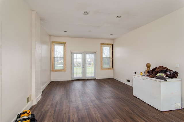 unfurnished room with dark hardwood / wood-style floors and french doors