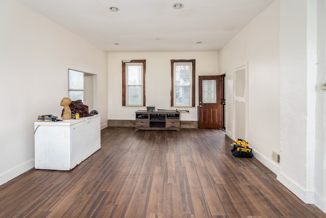 unfurnished office with dark hardwood / wood-style floors