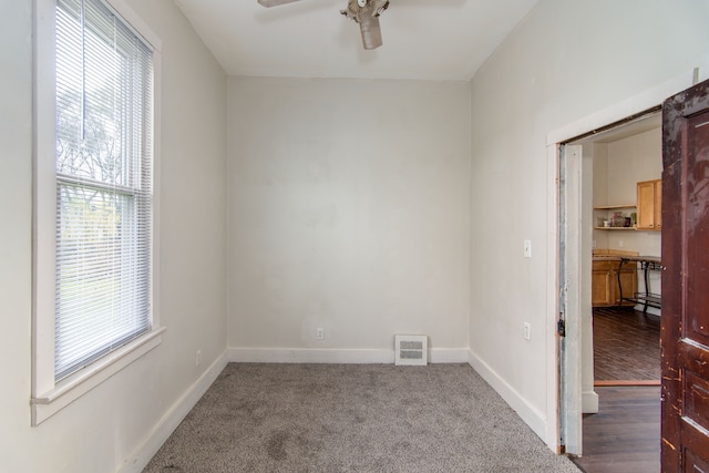 spare room with ceiling fan and dark wood-type flooring