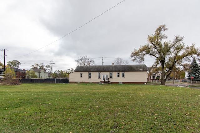 rear view of house with a lawn