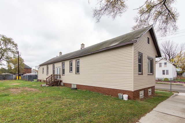 view of side of home with a lawn