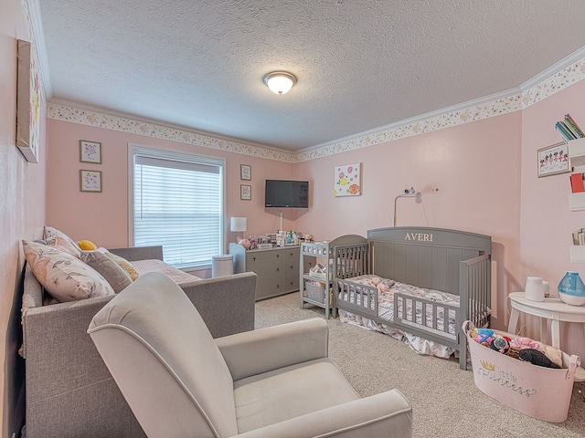 bedroom with carpet flooring, crown molding, a textured ceiling, and a crib