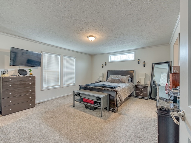 carpeted bedroom with ornamental molding and a textured ceiling