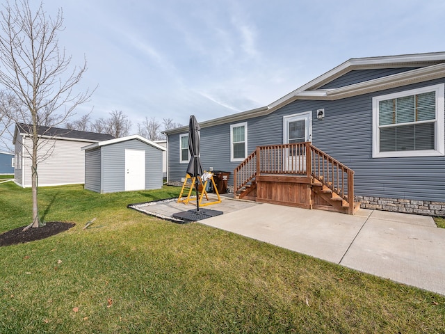 rear view of house featuring a lawn, a shed, and a patio