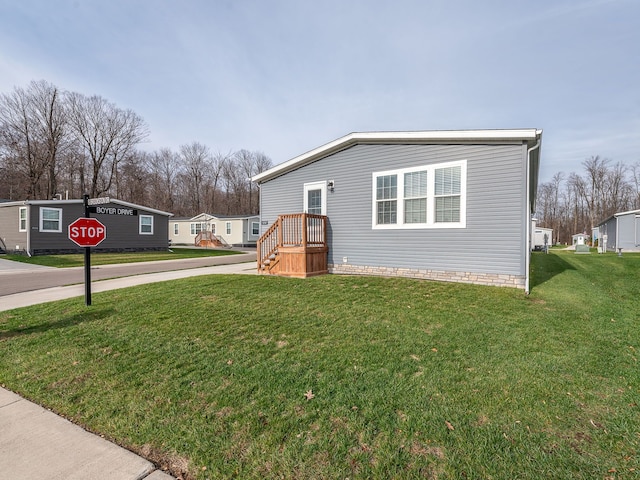 view of side of property with a lawn