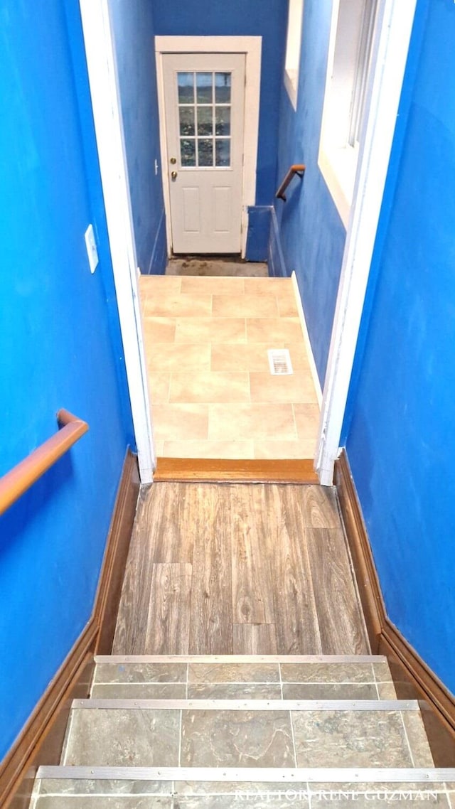 stairway featuring wood-type flooring