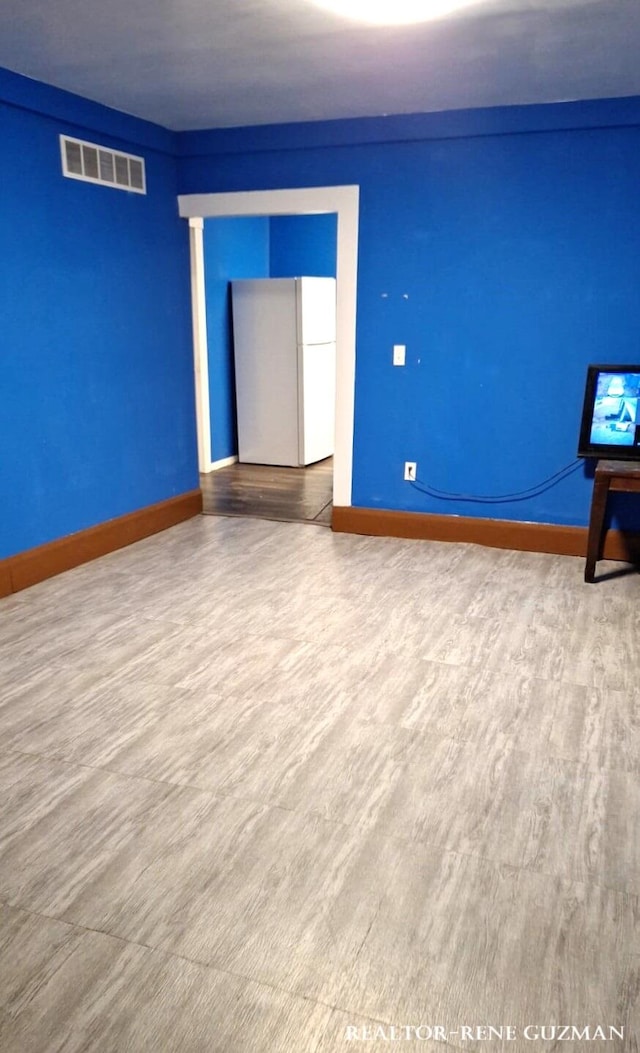 spare room with hardwood / wood-style floors