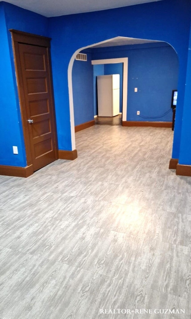 spare room with hardwood / wood-style flooring