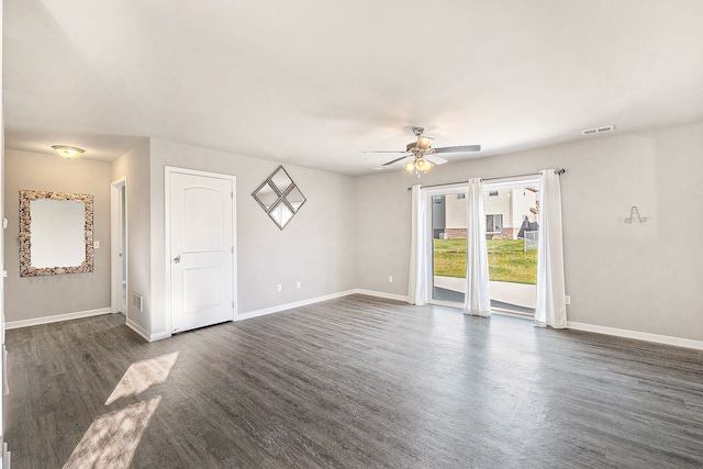 spare room with dark hardwood / wood-style floors and ceiling fan