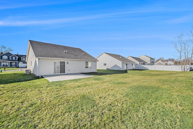 rear view of house with a yard and a patio