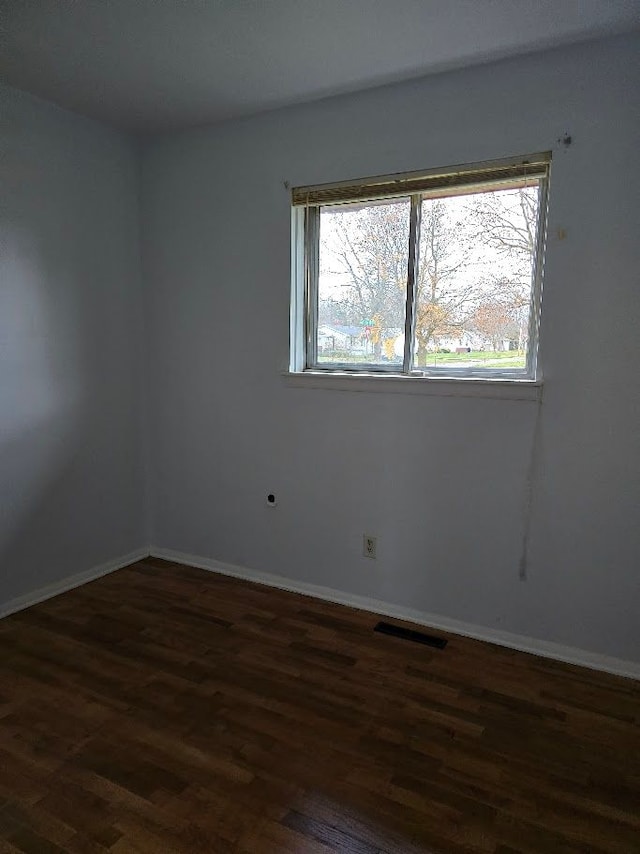 unfurnished room featuring dark hardwood / wood-style flooring