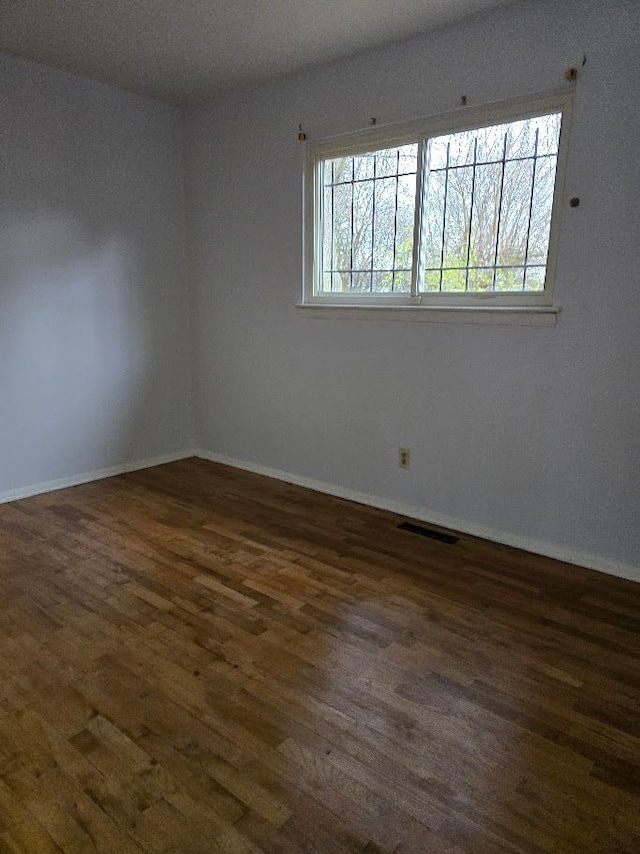 spare room featuring dark hardwood / wood-style floors