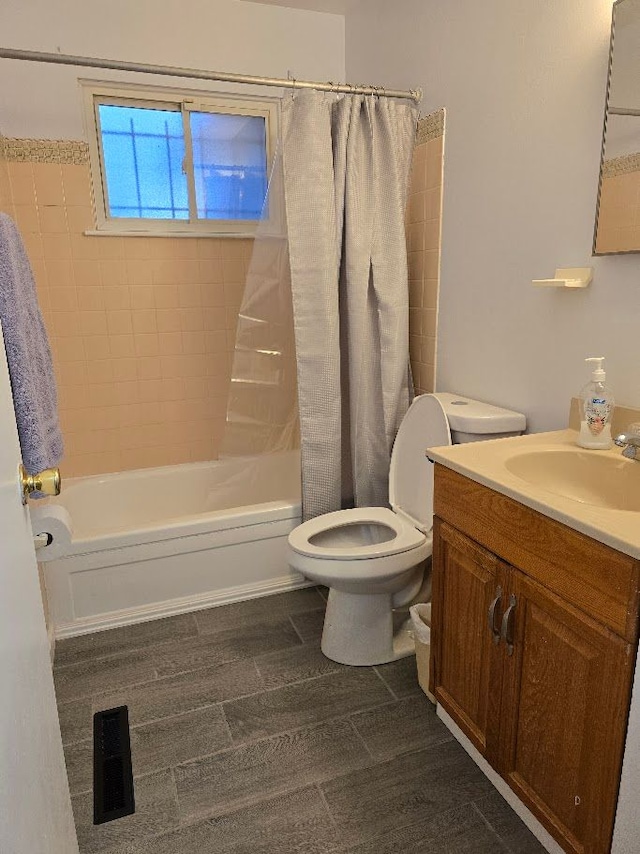 full bathroom featuring shower / bath combination with curtain, toilet, and vanity