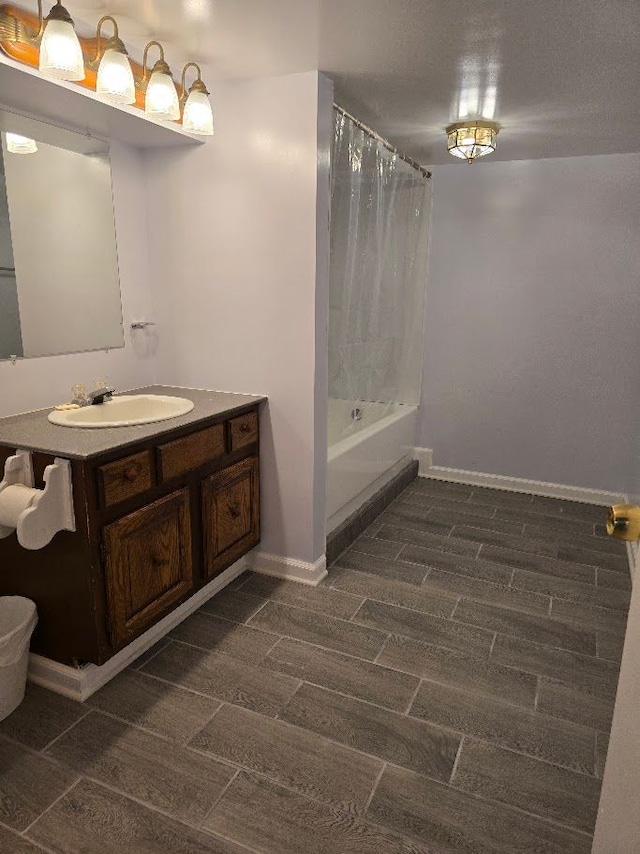 bathroom featuring hardwood / wood-style floors, vanity, and shower / bath combination with curtain